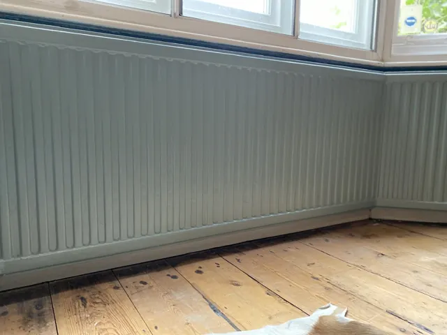 Bay window with freshly painted wall panelling, ready for curtains