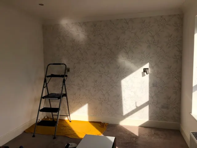 Bedroom with a newly hung patterned feature wall
